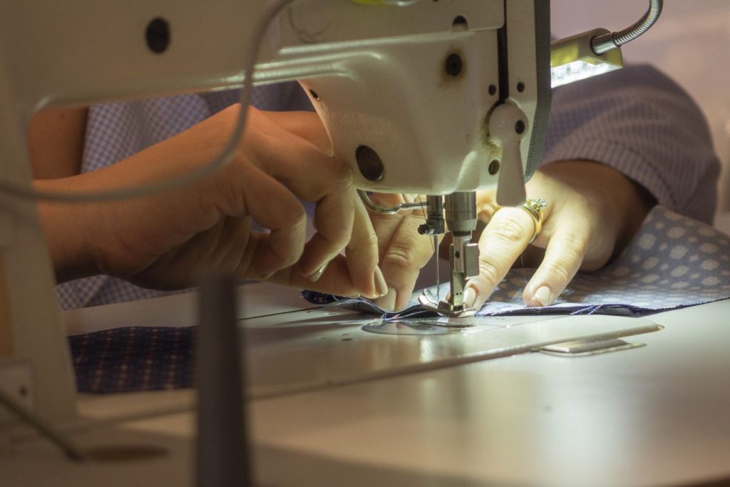 seamstress dm ties while sewing a necktie